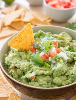 Guacamole - In brown Bowl with Chips on Top and on Side