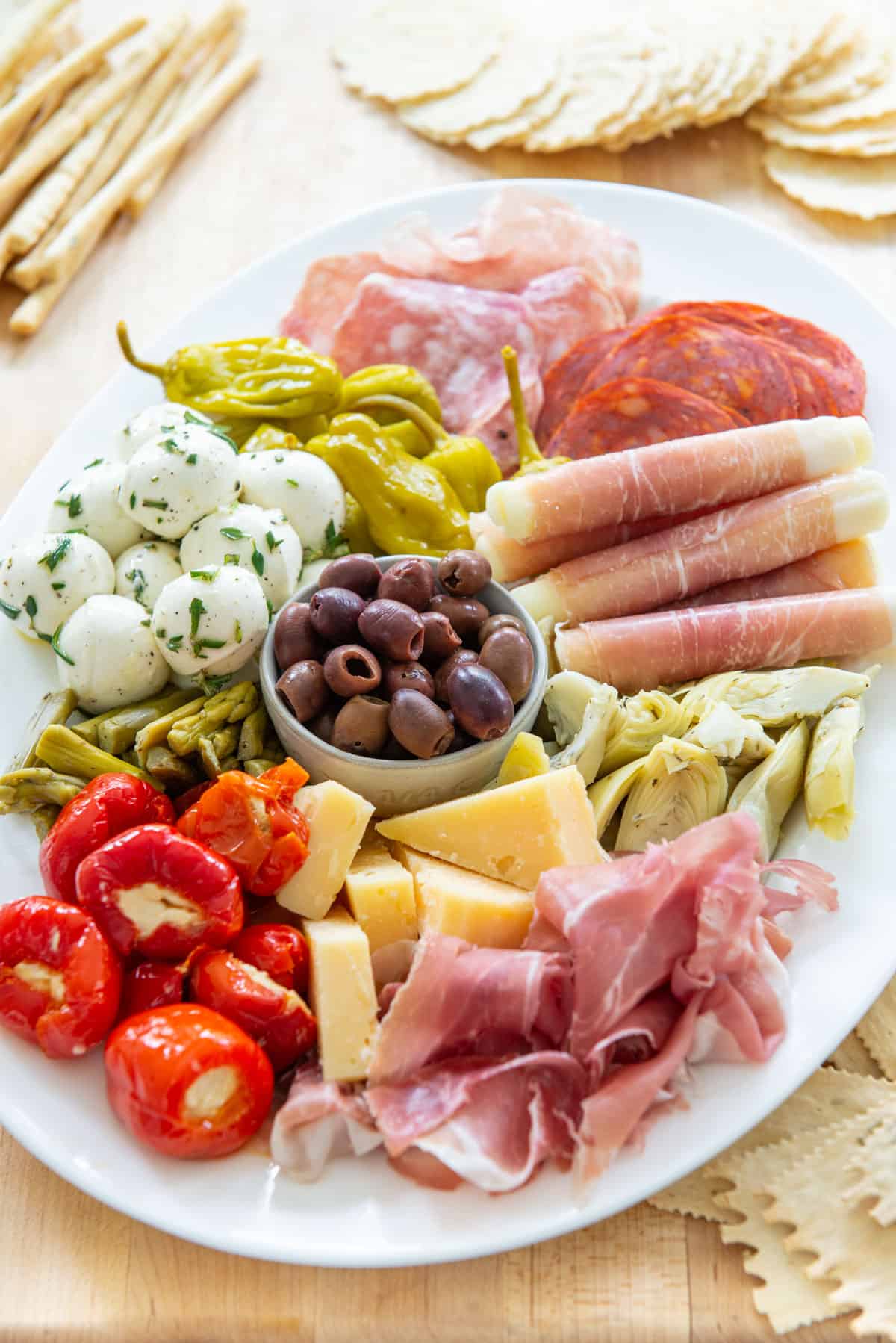 Antipasto Platter on a Wooden Board with Crackers